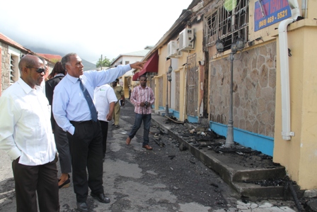 Prime Minister of St. Kitts and Nevis the Right Hon. Dr. Denzil Douglas (l) and Premier of Nevis Hon. Vance Amory (r) leaving Bath Hotel for a tour of the burnt Treasury Building in Charlestown at the end of a meeting on January 24, 2014. They are accompanied by Assistant Commissioner of Police attached to the Nevis Division Robert Liburd
